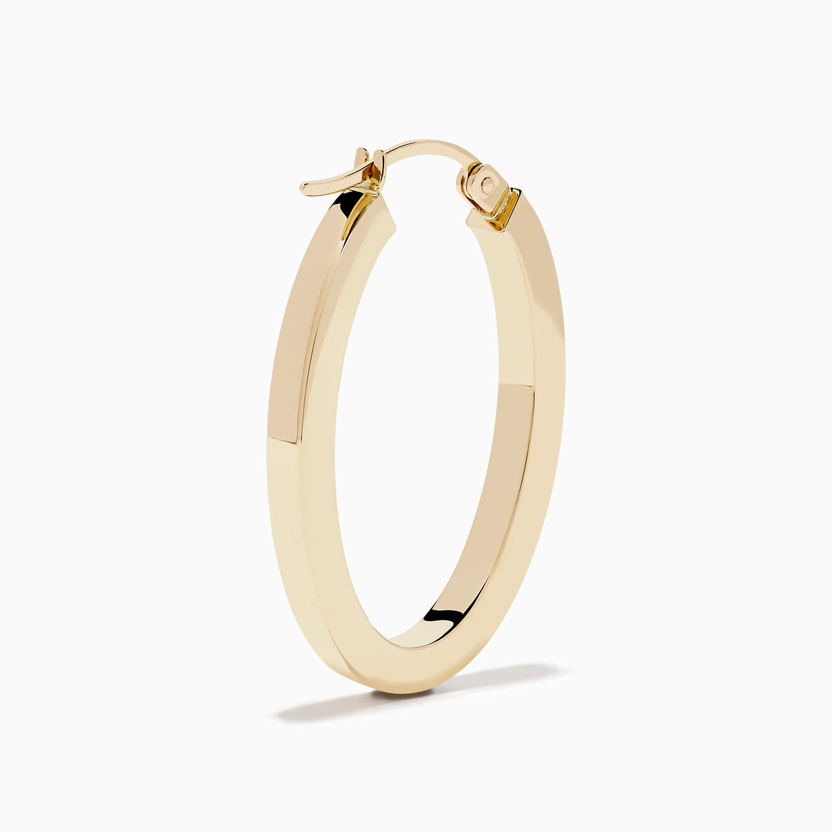 A pair of 14K Yellow Gold Square Tube Oval Hoop Earrings displayed vertically on a white background, casting soft shadows to the right.