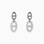 The 925 Sterling Silver Diamond Interlocking Link Earrings feature oval-shaped drops outlined with sparkling stones, each joined to a smaller oval loop for added diamond-inspired elegance.