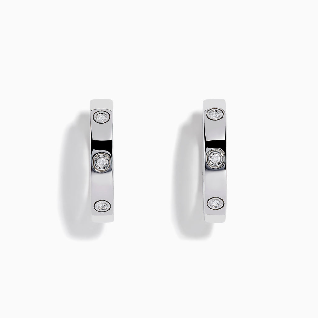 The 925 Sterling Silver Diamond Huggie Earrings feature three round diamonds set evenly along each polished hoop, shown against a white background.