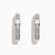 The 925 Sterling Silver Diamond Hoop Earrings feature rectangular sections with small, embedded clear stones, displayed on a plain white background.