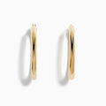 These 14K Yellow Gold Hollow Large Round Hoop Earrings feature a smooth, polished finish and are displayed against a plain white background.