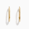 A pair of 14K Yellow Gold Rhombus Tube Hoop Earrings with a shiny, geometric shape, displayed on a white background.