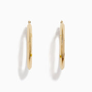 A pair of 14K Yellow Gold Rhombus Tube Hoop Earrings with a shiny, geometric shape, displayed on a white background.