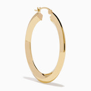 A pair of 14K Yellow Gold Rhombus Tube Hoop Earrings with a shiny, geometric shape, displayed on a white background.