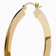 A pair of 14K Yellow Gold Rhombus Tube Hoop Earrings with a shiny, geometric shape, displayed on a white background.