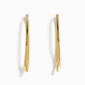 The 14K Yellow Gold Hollow Bypass Hoop Earrings feature two parallel strands in a sleek drop design with a smooth, shiny finish, elegantly displayed against a white background.