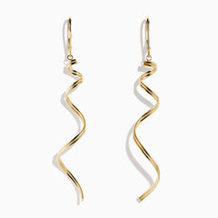 The 14K Yellow Gold Swirl Linear Drop Earrings feature a long, twisted spiral design and are shown against a plain white background.
