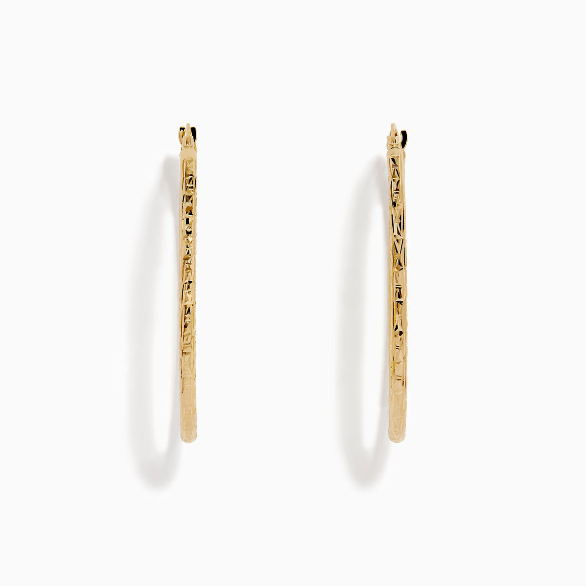 A pair of 14K Yellow Gold Oval Tube Baguette Cut Hoop Earrings, thin and textured, are displayed vertically with clasps at the top against a plain white background.