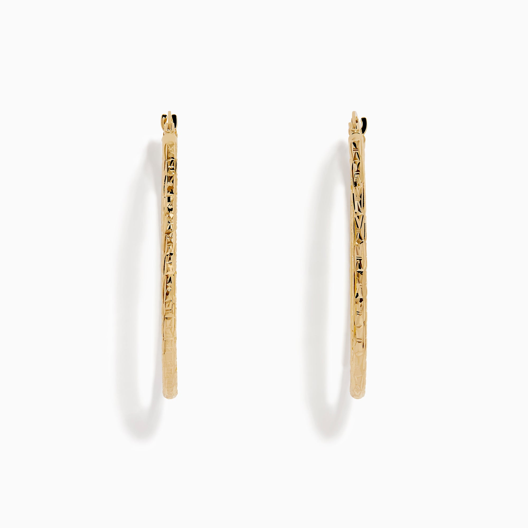 A pair of 14K Yellow Gold Oval Tube Baguette Cut Hoop Earrings, thin and textured, are displayed vertically with clasps at the top against a plain white background.