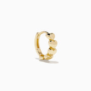 The 14K Yellow Gold Polished Heart Huggie Hoop Earrings feature a vertical row of shiny heart-shaped segments, elegantly displayed against a plain white background.