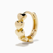 The 14K Yellow Gold Polished Heart Huggie Hoop Earrings feature a vertical row of shiny heart-shaped segments, elegantly displayed against a plain white background.