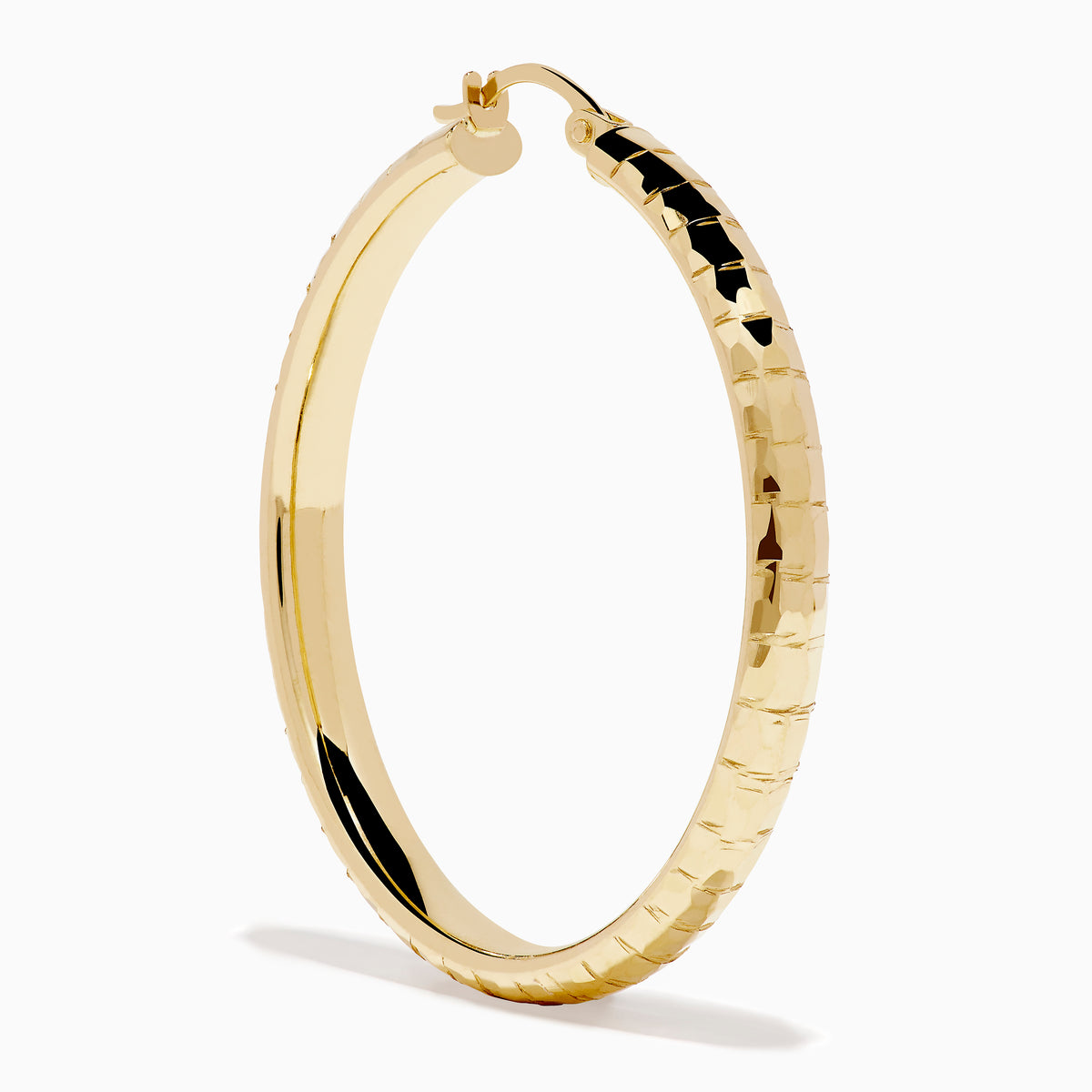 The 14K Yellow Gold Reverse Vibrant Cut Hoop Earrings feature a large, eye-catching design and are showcased against a plain white background with soft shadows.