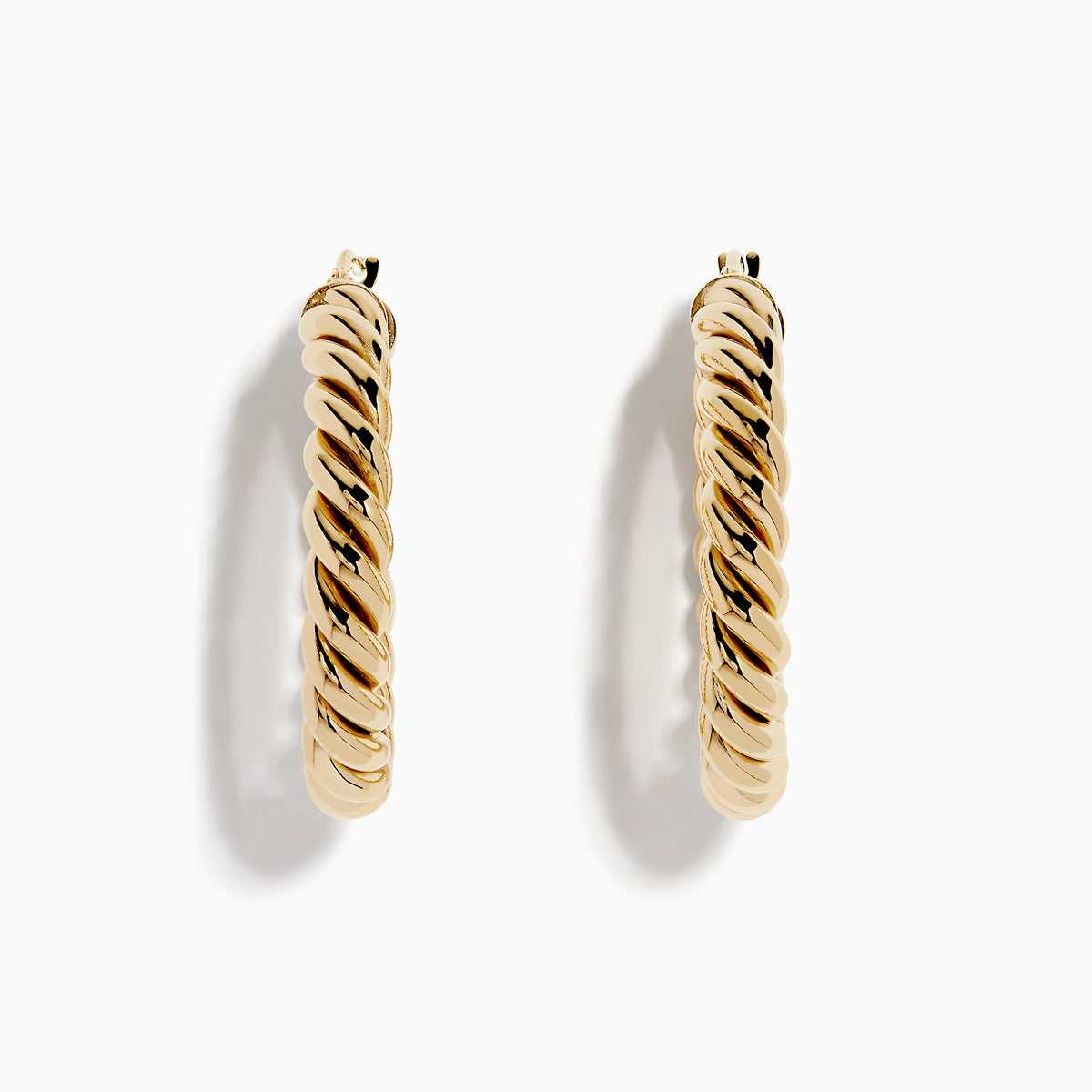 The 14K Yellow Gold Twisted Tube Hoops are shown on a white background, with gentle shadows highlighting their elegant design.