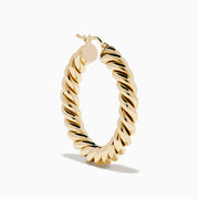 The 14K Yellow Gold Twisted Tube Hoops are shown on a white background, with gentle shadows highlighting their elegant design.
