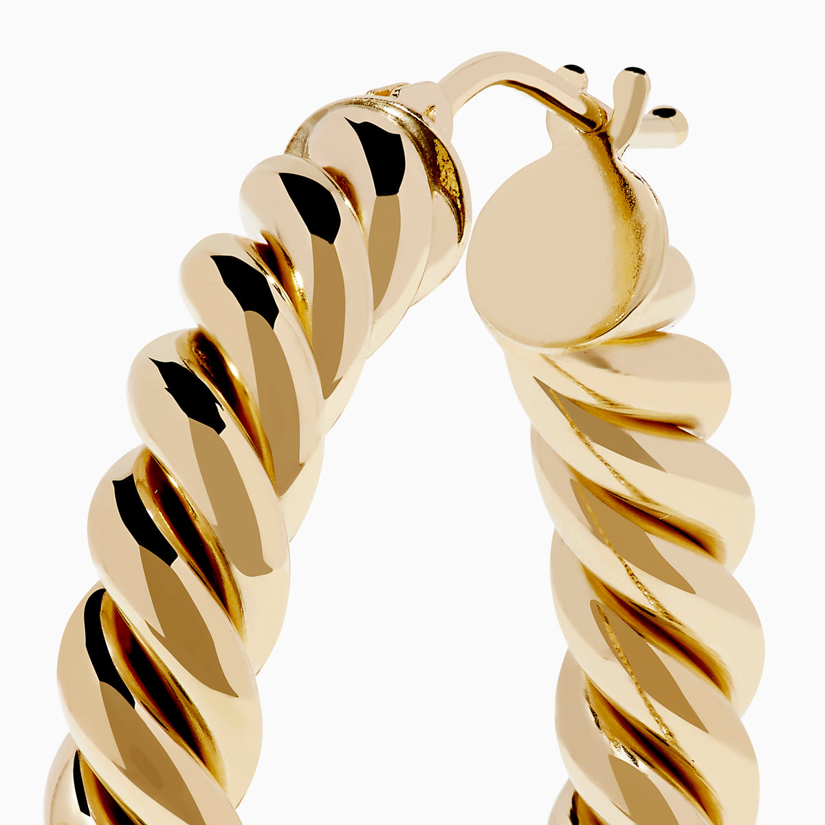 The 14K Yellow Gold Twisted Tube Hoops are shown on a white background, with gentle shadows highlighting their elegant design.