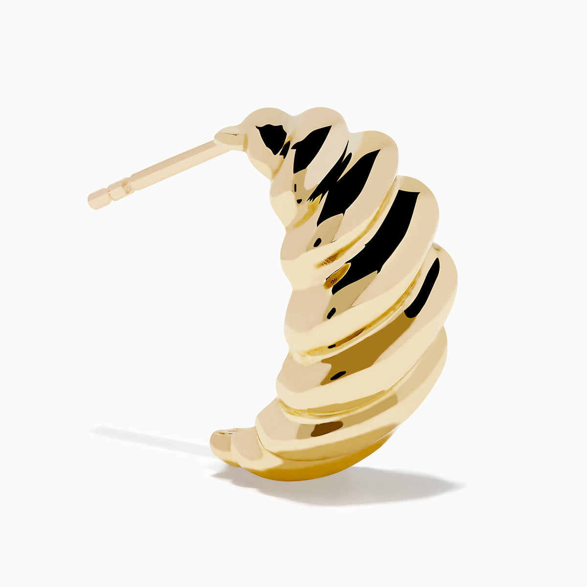 The 14K Yellow Gold Croissant Huggie Earrings feature an oval shape with a ridged, twisted design, shown on a white background.