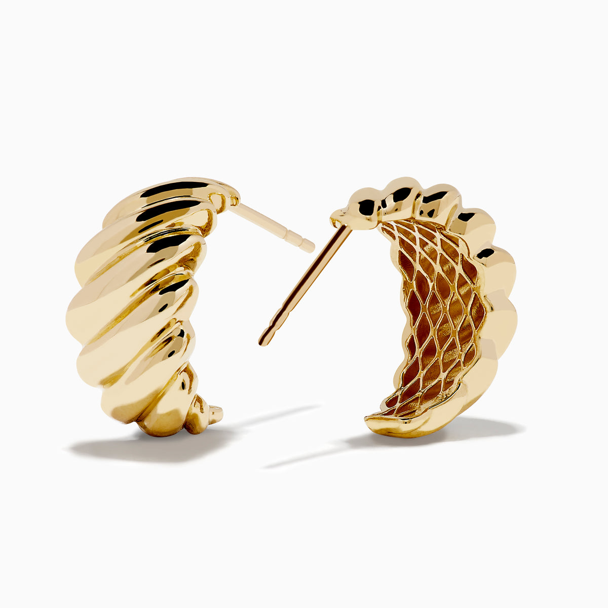 The 14K Yellow Gold Croissant Huggie Earrings feature an oval shape with a ridged, twisted design, shown on a white background.