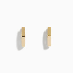 A pair of minimalist 14K Yellow Gold Hexagon Huggies displayed upright on a plain white background.
