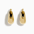 A pair of 14K yellow gold graduated oval chunky hoop earrings with a smooth, curved surface and clasp fastening, displayed on a white background.