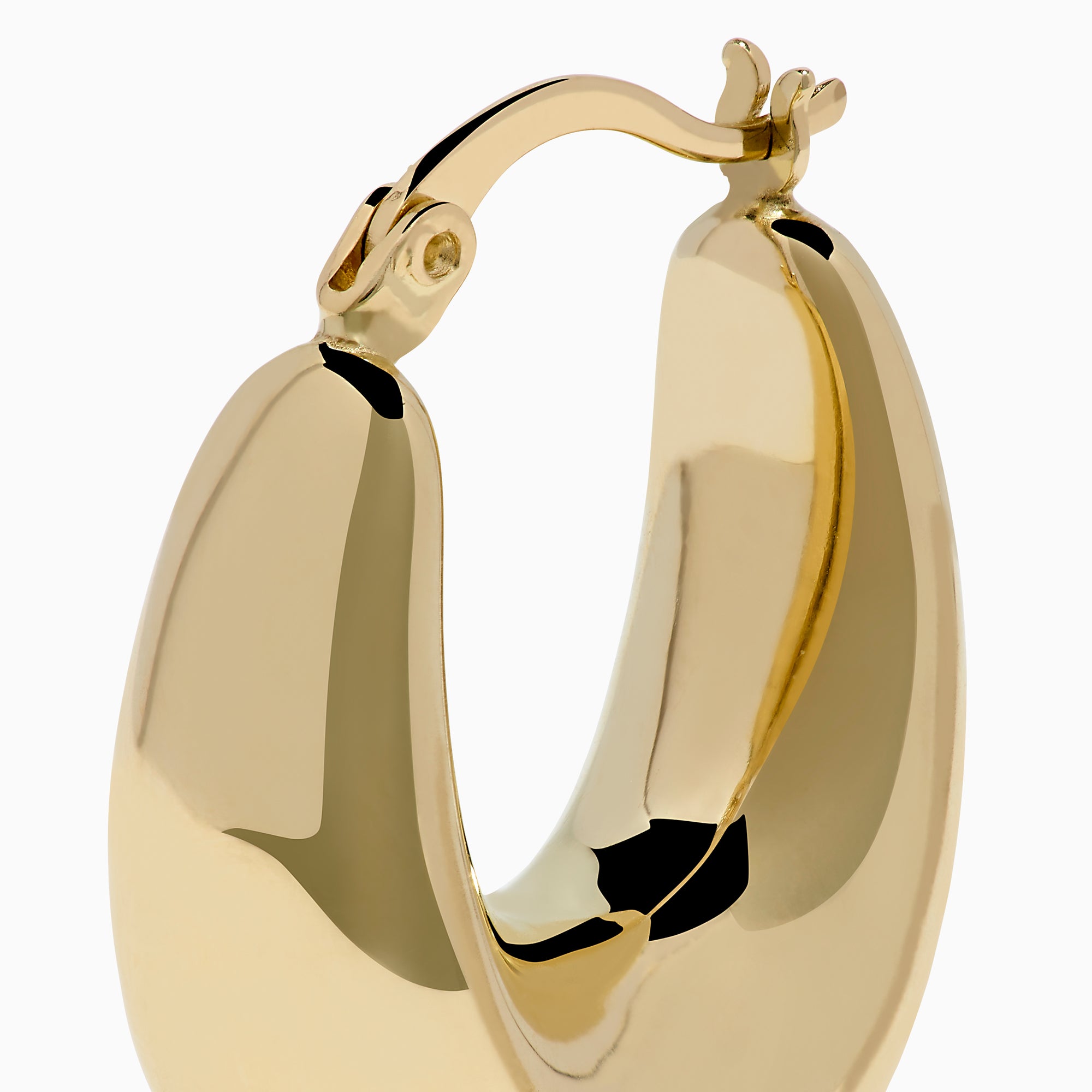 A pair of 14K yellow gold graduated oval chunky hoop earrings with a smooth, curved surface and clasp fastening, displayed on a white background.