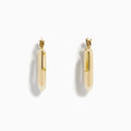 The 14K Yellow Gold Geometric Hoops feature a faceted, hexagonal design and are shown upright against a plain white background.