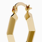 The 14K Yellow Gold Geometric Hoops feature a faceted, hexagonal design and are shown upright against a plain white background.