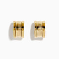 The 14K Yellow Gold Chunky Huggie Earrings feature a ridged, cylindrical design and are shown against a white background.