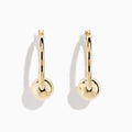 A pair of 14K yellow gold tube hoops with bead accents, displayed against a plain white background.