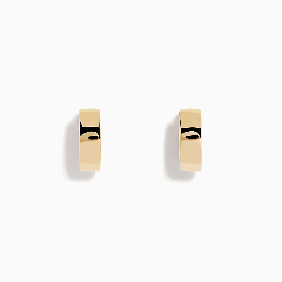 The 14K Yellow Gold Huggies are simple, small earrings with a smooth, shiny finish, shown on a plain white background.