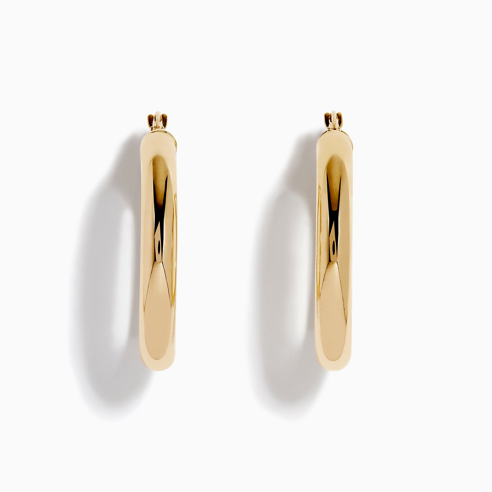 The 14K Yellow Gold Tube Hoop Earrings are shown vertically on a plain white background, with soft shadows cast to the left.