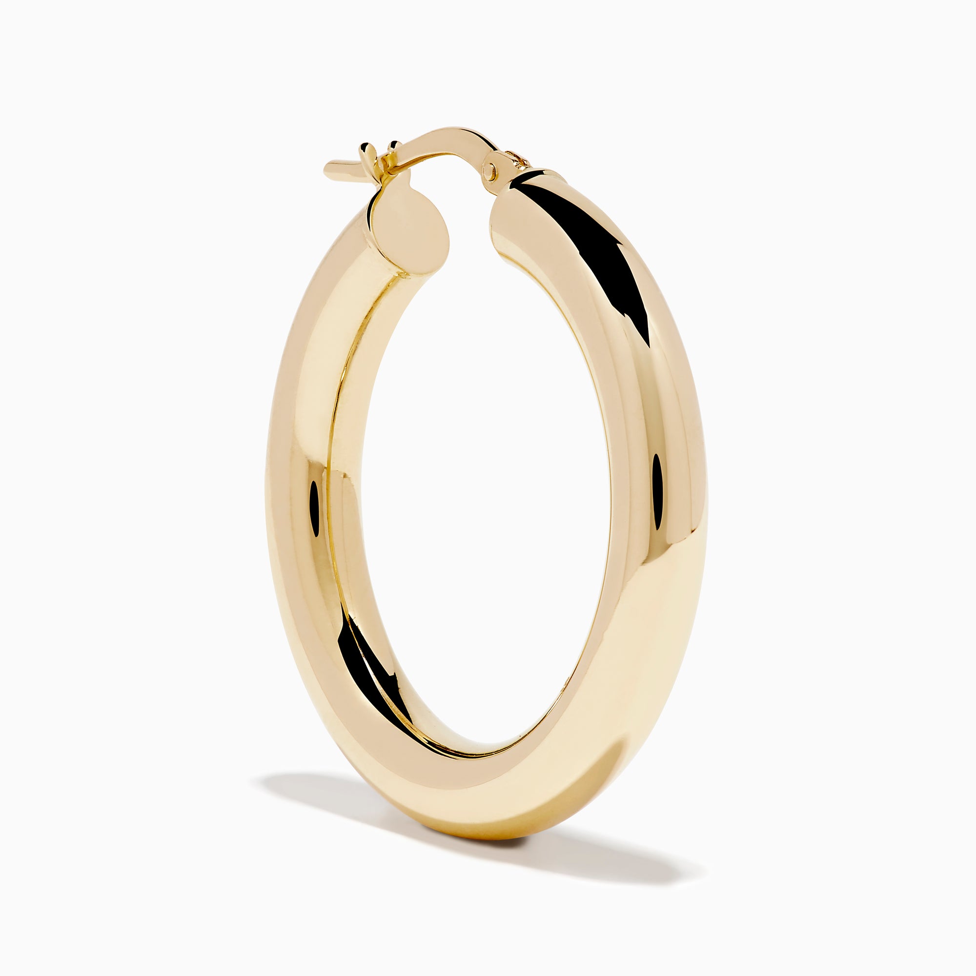 The 14K Yellow Gold Tube Hoop Earrings are shown vertically on a plain white background, with soft shadows cast to the left.