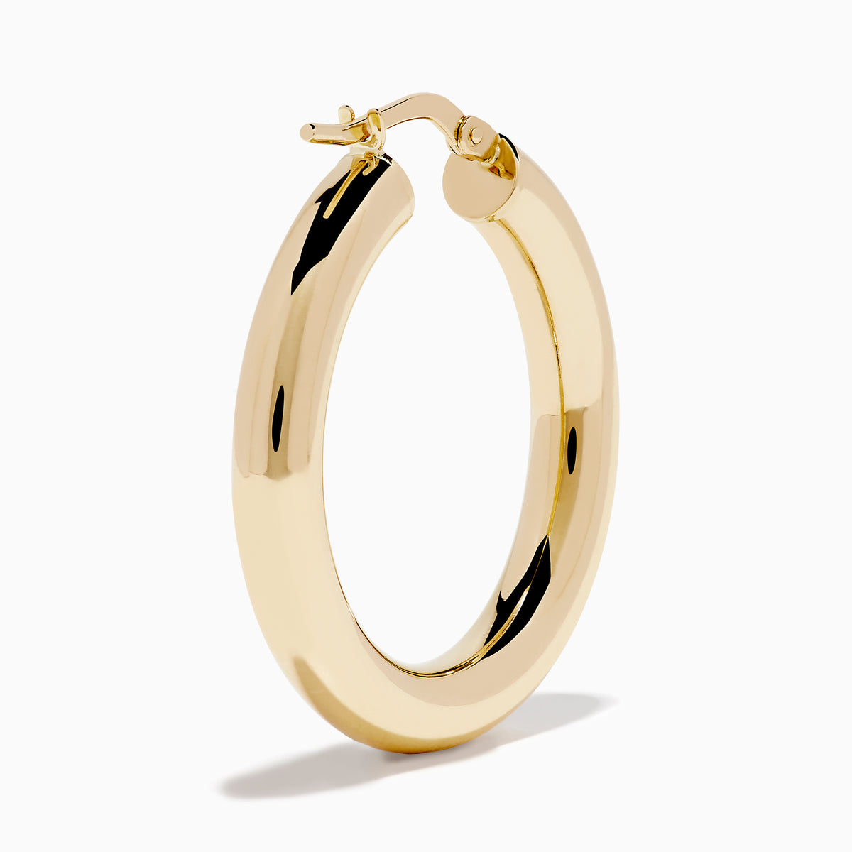 The 14K Yellow Gold Tube Hoop Earrings are shown vertically on a plain white background, with soft shadows cast to the left.