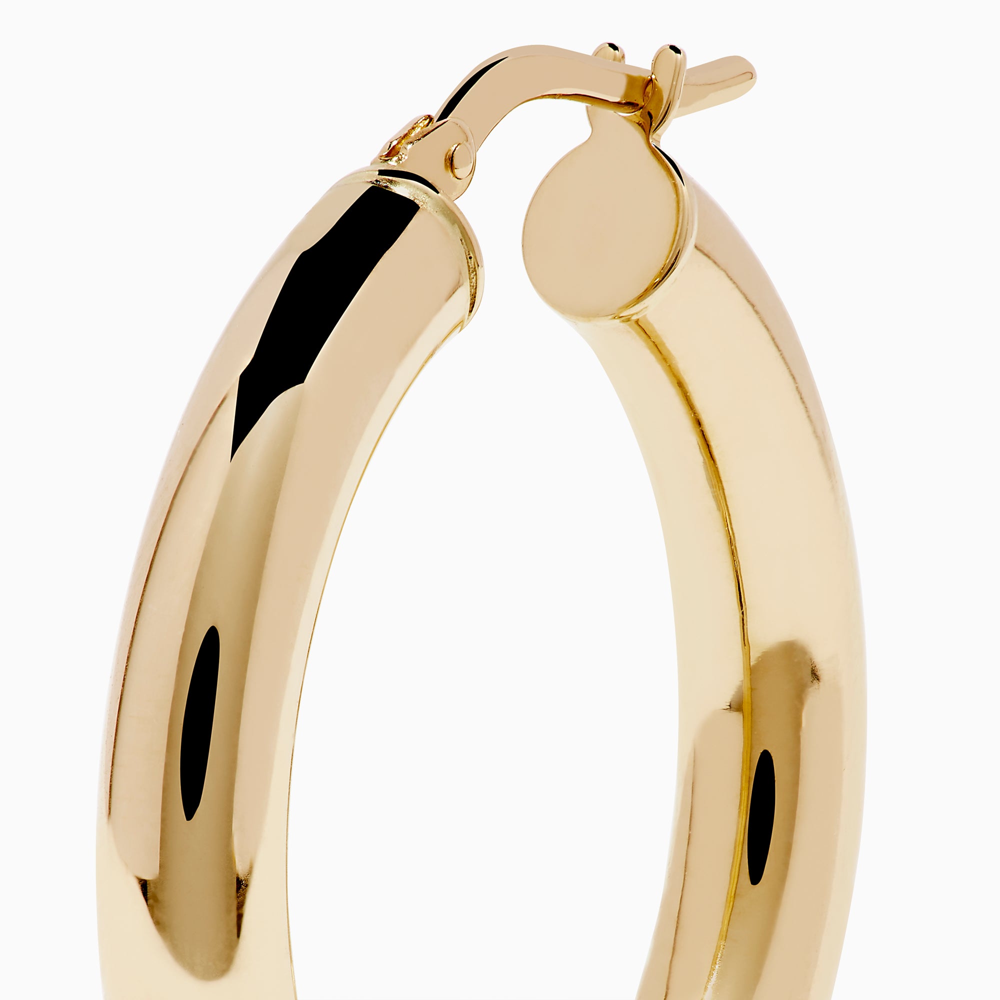 The 14K Yellow Gold Tube Hoop Earrings are shown vertically on a plain white background, with soft shadows cast to the left.