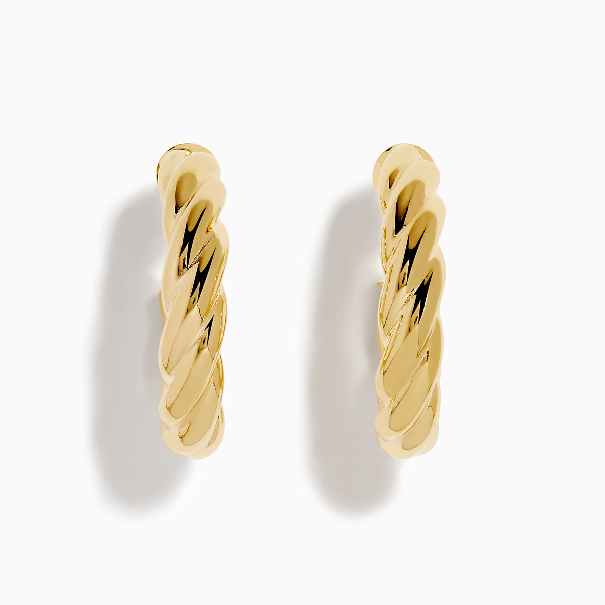 The 14K Yellow Gold Twist Hoop Earrings are shown against a white background, with soft shadows cast to the left.