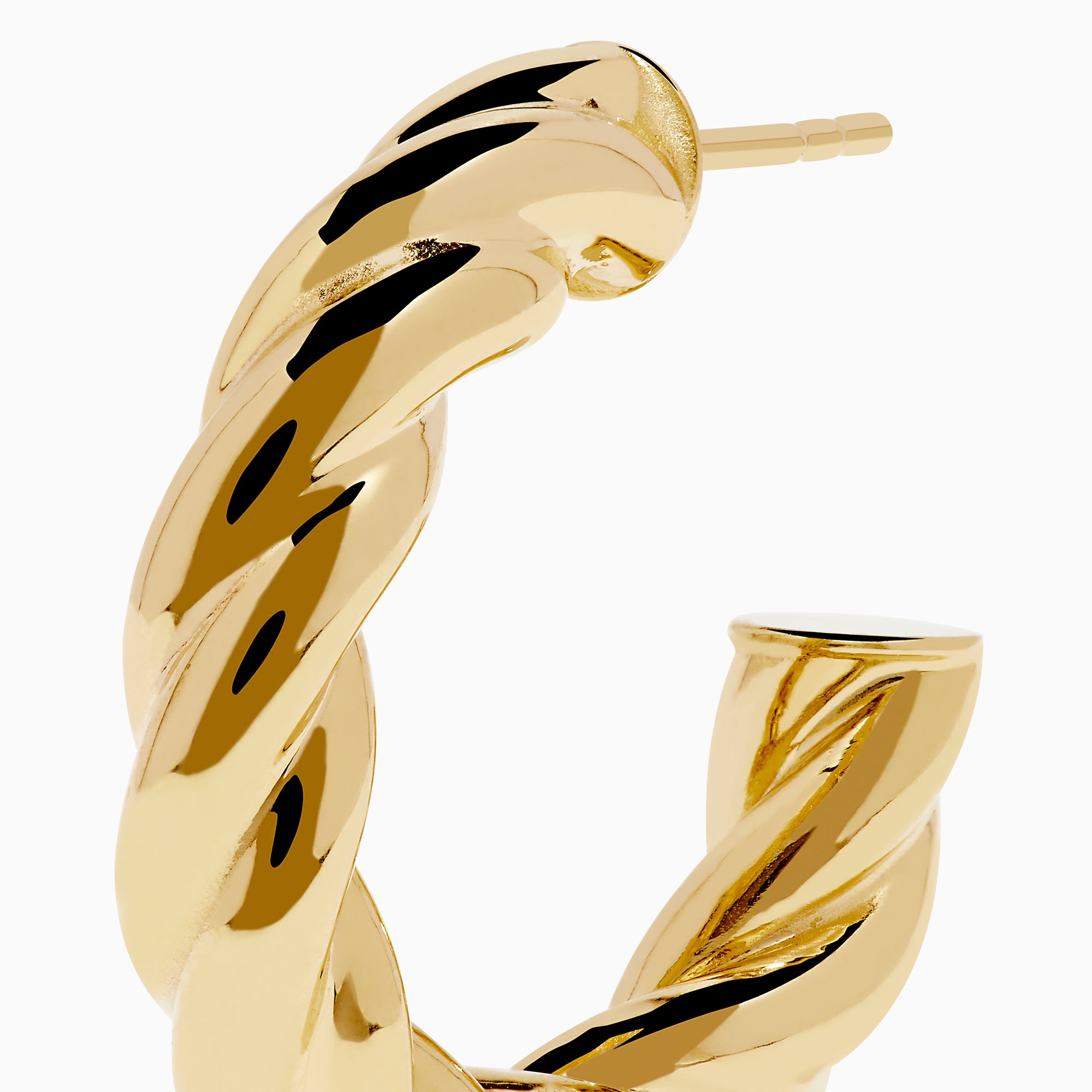 The 14K Yellow Gold Twist Hoop Earrings are shown against a white background, with soft shadows cast to the left.