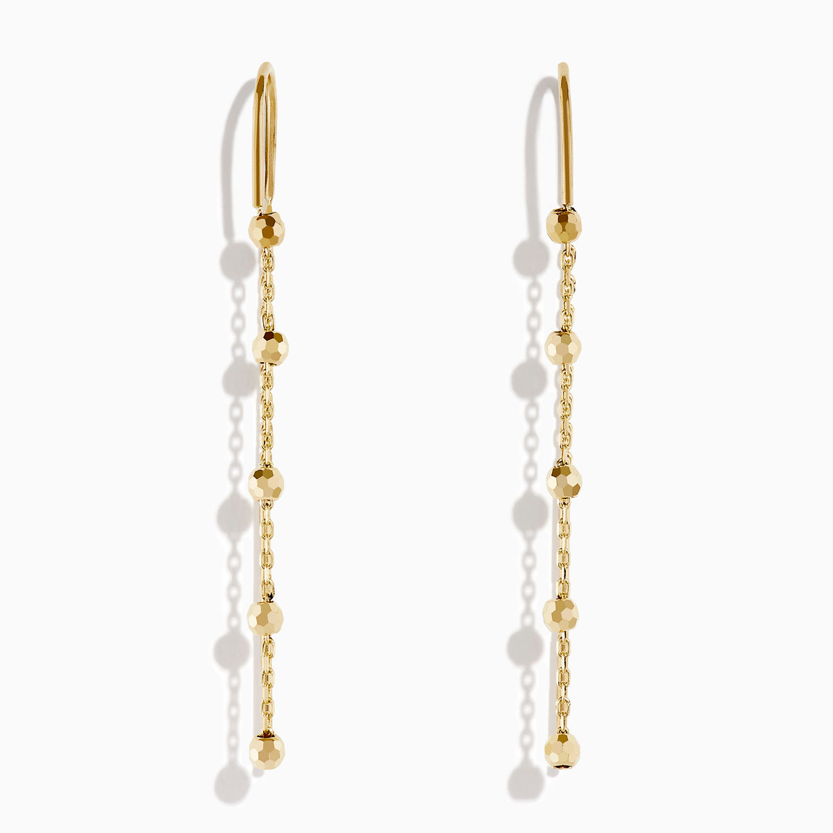The 14K Yellow Gold Linear Drop Earrings showcase a minimalist design with slim chains and small, spaced gold beads. Crafted in 14K yellow gold, these earrings hang vertically from hooks for a timeless, elegant style.