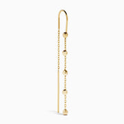 The 14K Yellow Gold Linear Drop Earrings showcase a minimalist design with slim chains and small, spaced gold beads. Crafted in 14K yellow gold, these earrings hang vertically from hooks for a timeless, elegant style.