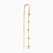 The 14K Yellow Gold Linear Drop Earrings showcase a minimalist design with slim chains and small, spaced gold beads. Crafted in 14K yellow gold, these earrings hang vertically from hooks for a timeless, elegant style.