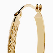 A pair of 14K Yellow Gold Knife Edge Tube Hoop Earrings with a textured finish, displayed on a plain white background and shown facing forward with visible clasps at the top.