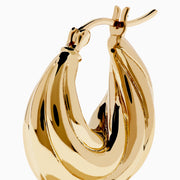 The 14K Yellow Gold Shrimp Hoop Earrings feature a twisted, sculptural teardrop design and are displayed on a white background.