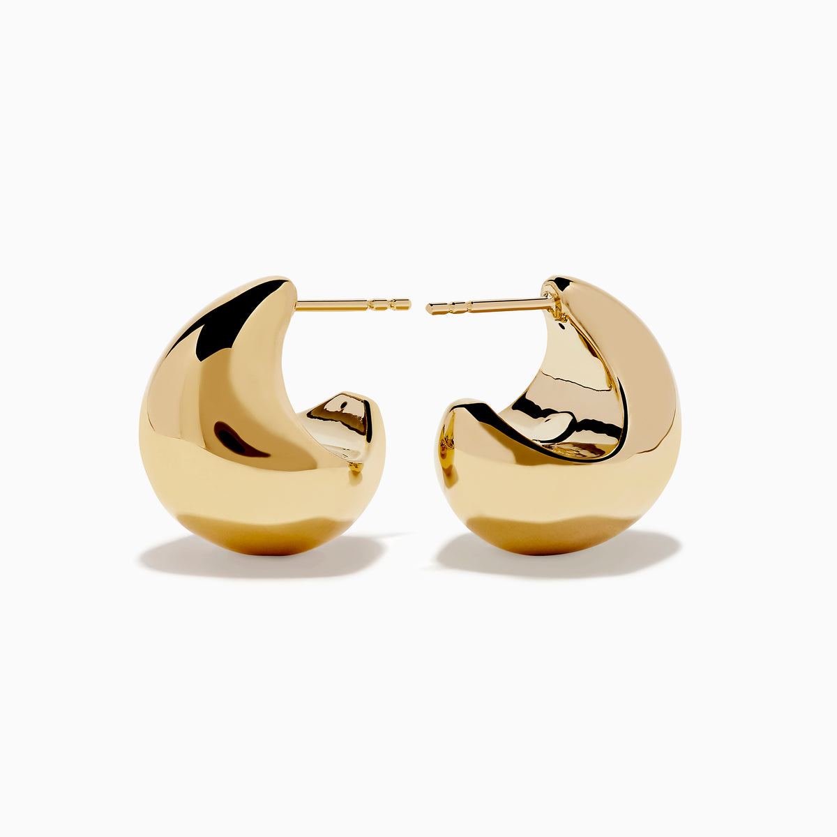 A pair of 14K Yellow Gold Chunky Stud Earrings with shiny, abstract curves and smooth surfaces, shown on a plain white background.