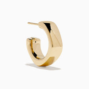 A pair of 14K Yellow Gold Hoop Earrings is shown vertically on a white background, casting soft shadows to the left.