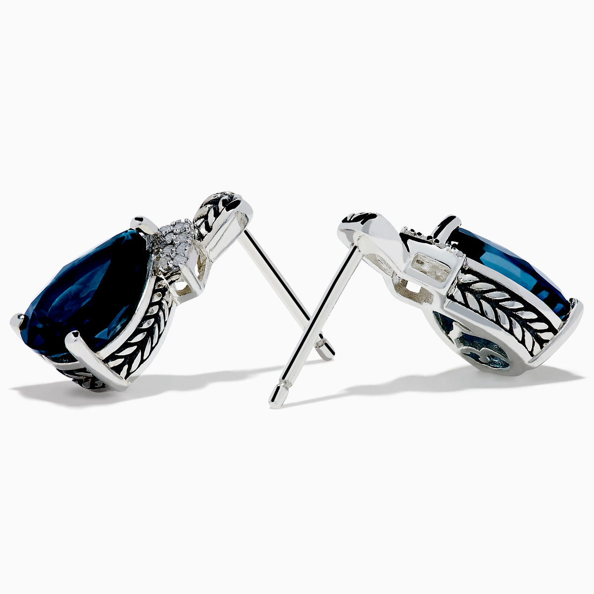 The Ocean Bleu 925 Sterling Silver London Blue Topaz and Diamond Earrings showcase teardrop-shaped London Blue Topaz stones, accented with sparkling diamonds and a leaf-patterned sterling silver setting.