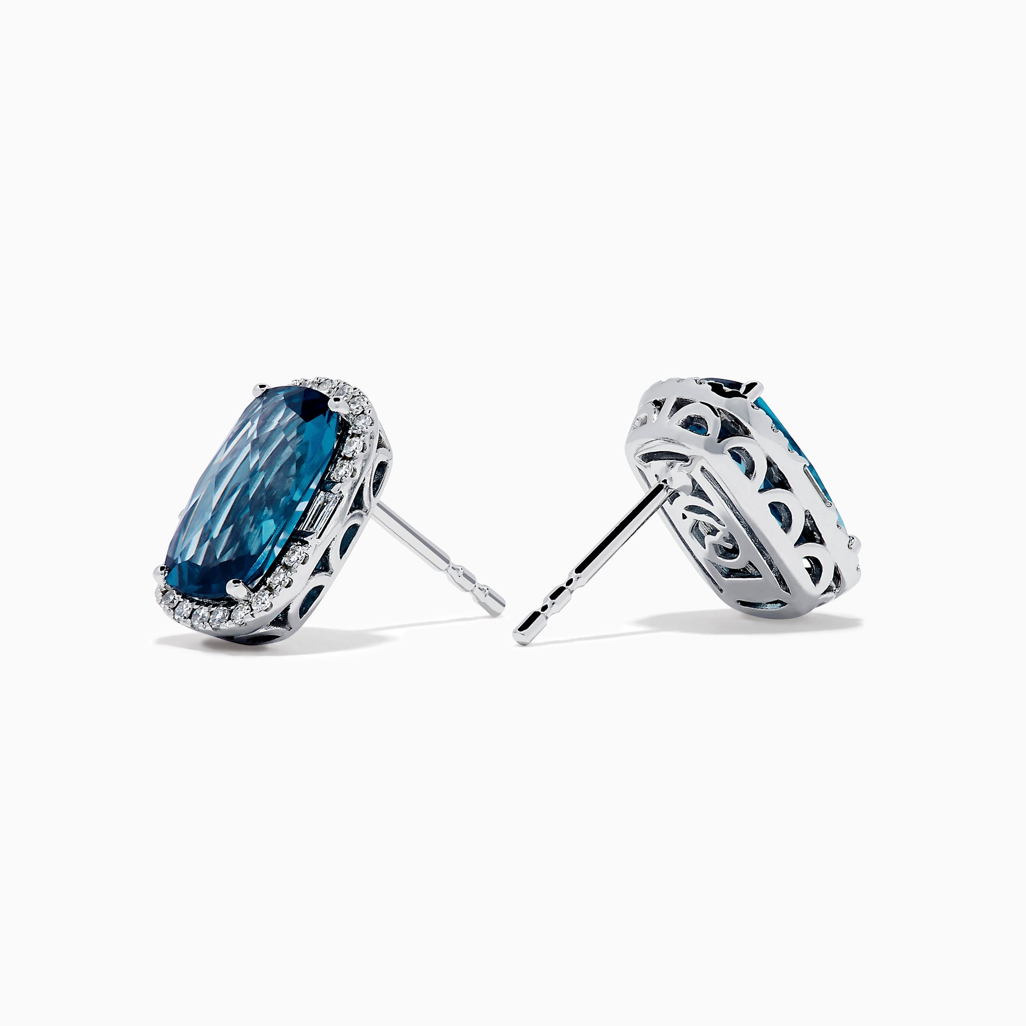 The 14K White Gold Elongated Cushion Blue Topaz and Diamond Halo Stud Earrings feature rectangular blue topaz stones encircled by shimmering diamonds for a timeless, elegant look.