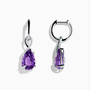 The 14K White Gold Amethyst and Diamond Earrings feature teardrop-shaped amethyst gems accented with a swirl of small white stones, all set in polished white gold and displayed on a white background.