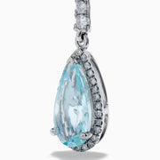 Elegant 14K white gold linear drop earrings featuring teardrop-shaped aquamarine gemstones, accented with diamonds.