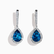Elegant 14K white gold dangle earrings showcasing teardrop blue topaz gemstones, accented with sparkling diamonds for a stunning look.
