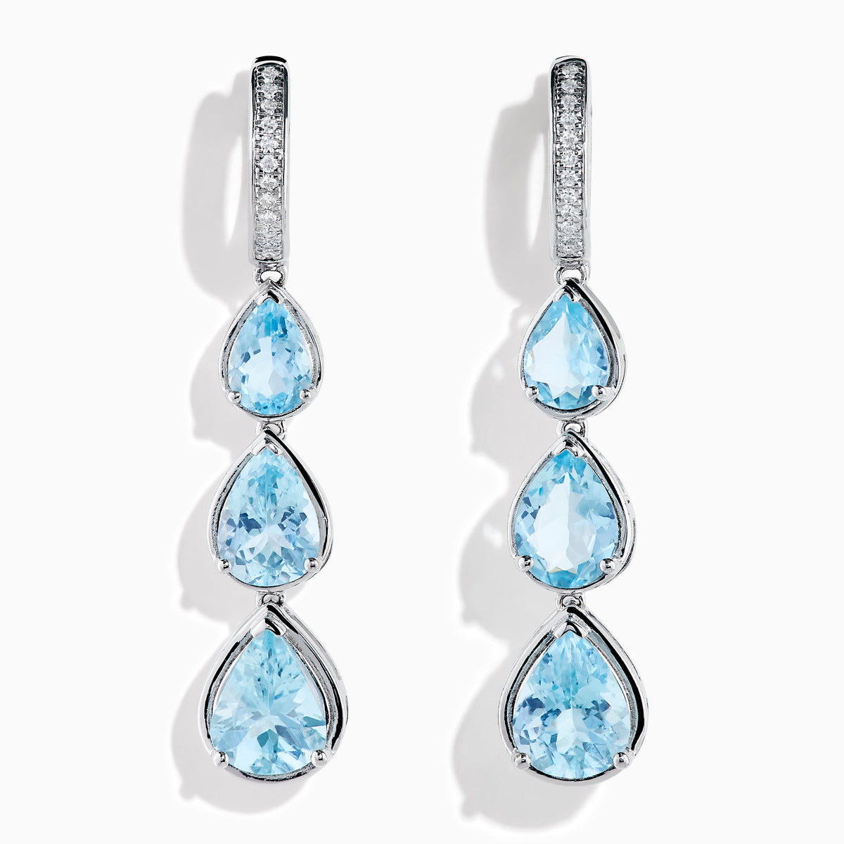 The 14K White Gold Aquamarine and Diamond Pear Shaped Linear Drop Earrings feature three vertically arranged pear-shaped aquamarines and diamond accents for extra sparkle.
