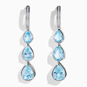 The 14K White Gold Aquamarine and Diamond Pear Shaped Linear Drop Earrings feature three vertically arranged pear-shaped aquamarines and diamond accents for extra sparkle.