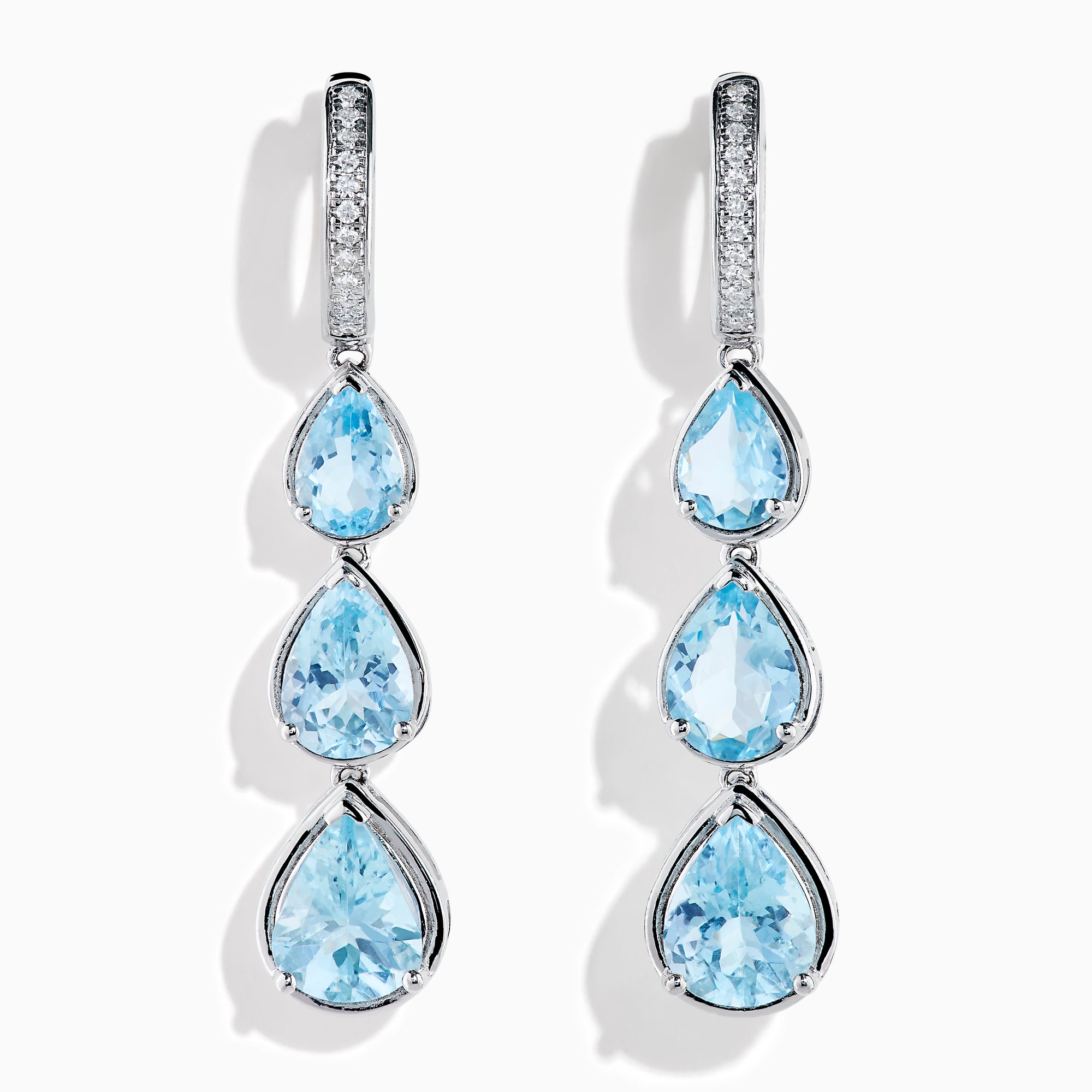 The 14K White Gold Aquamarine and Diamond Pear Shaped Linear Drop Earrings feature three vertically arranged pear-shaped aquamarines and diamond accents for extra sparkle.